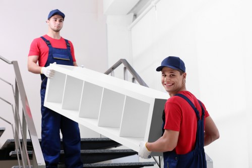 Loading furniture into a removals van on a residential street