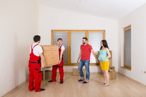 Local removal truck helping with furniture and boxes in West Harrow