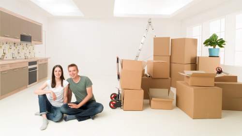 Professional movers loading items for a West Harrow relocation
