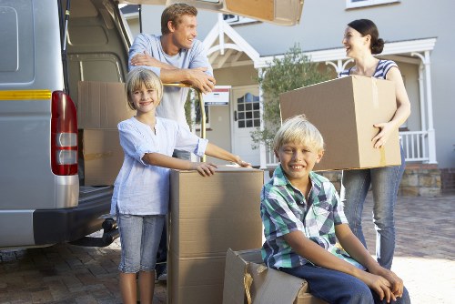 Furniture and household items being prepared for a West Harrow removal van