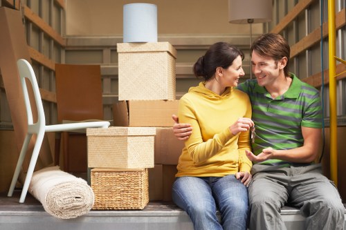 Professional movers handling furniture for a West Harrow relocation